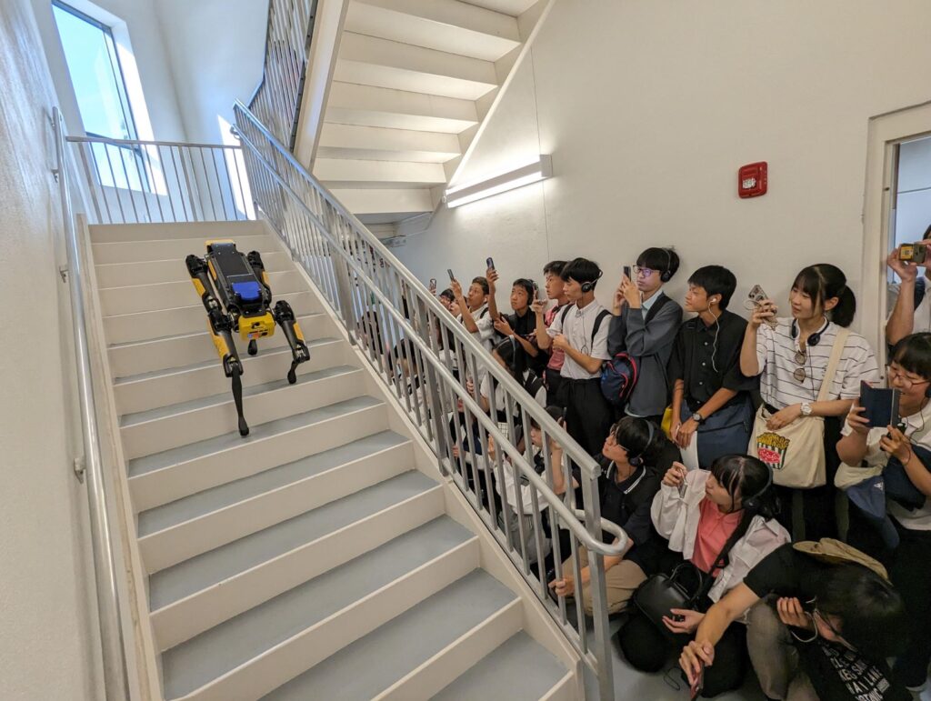 Japanese high school students observe TapeMeasure climb the stairs in Partnership 2.